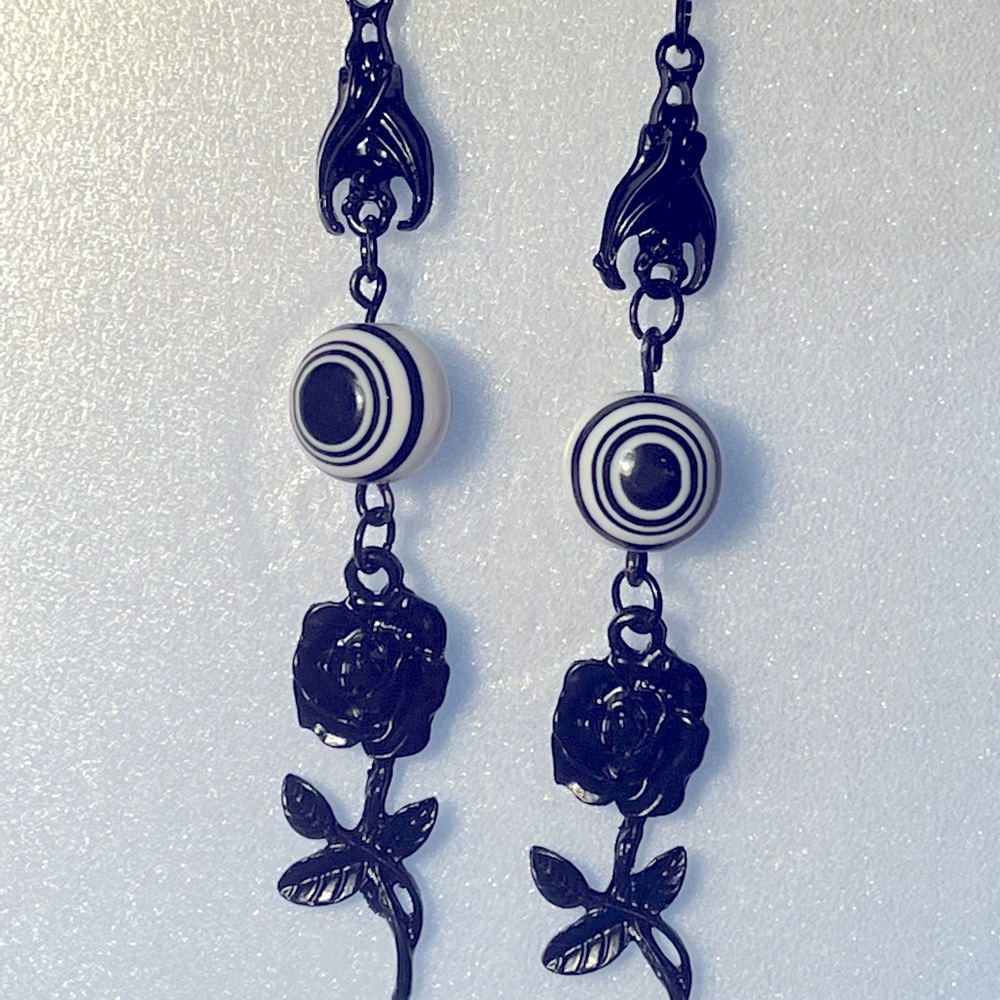 Handmade black and white earrings with rose and bat charms